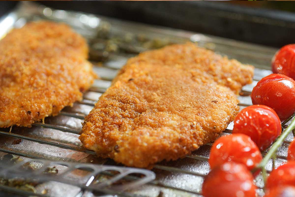 The cutlets straight out of the oven, deep golden and crisp on the wire rack