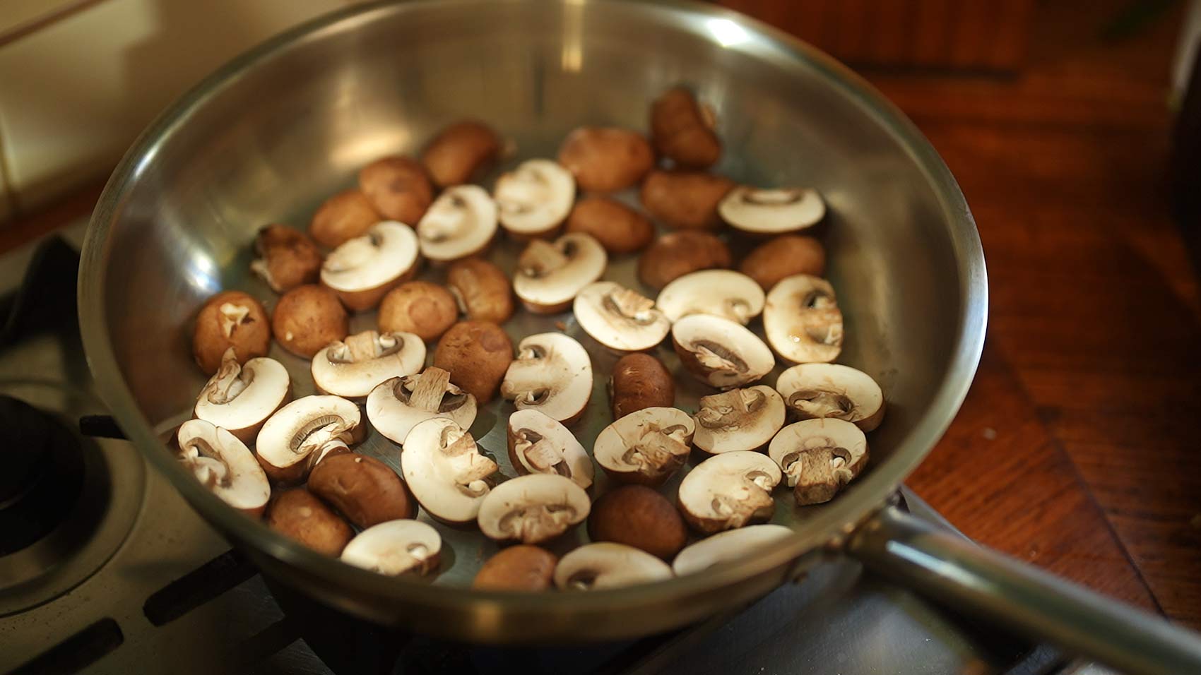 Mushrooms in a dry frying pan, releasing their liquid